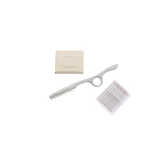 A pair of scissors and a box of toothpaste, along with an Extension Blending Razor.