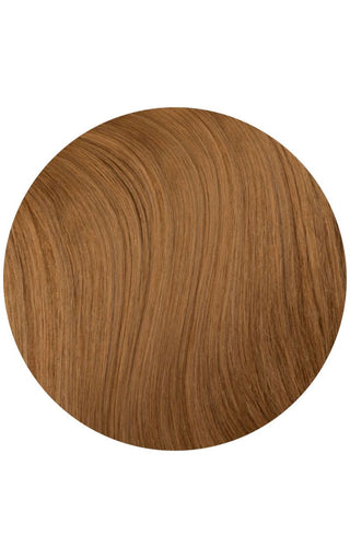 Pumpkin spice colored hair extension example on a white background in a circle shape