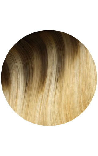 Rooted golden balayage highlights hair extension swatch on a white background.