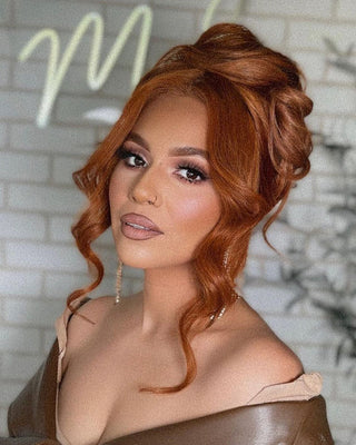 A woman with red hair extensions wearing a stylish brown leather dress, exuding confidence and elegance.