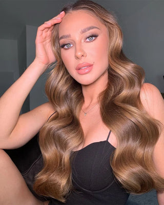 A woman with light ash brown Glam Seamless hair extensions.